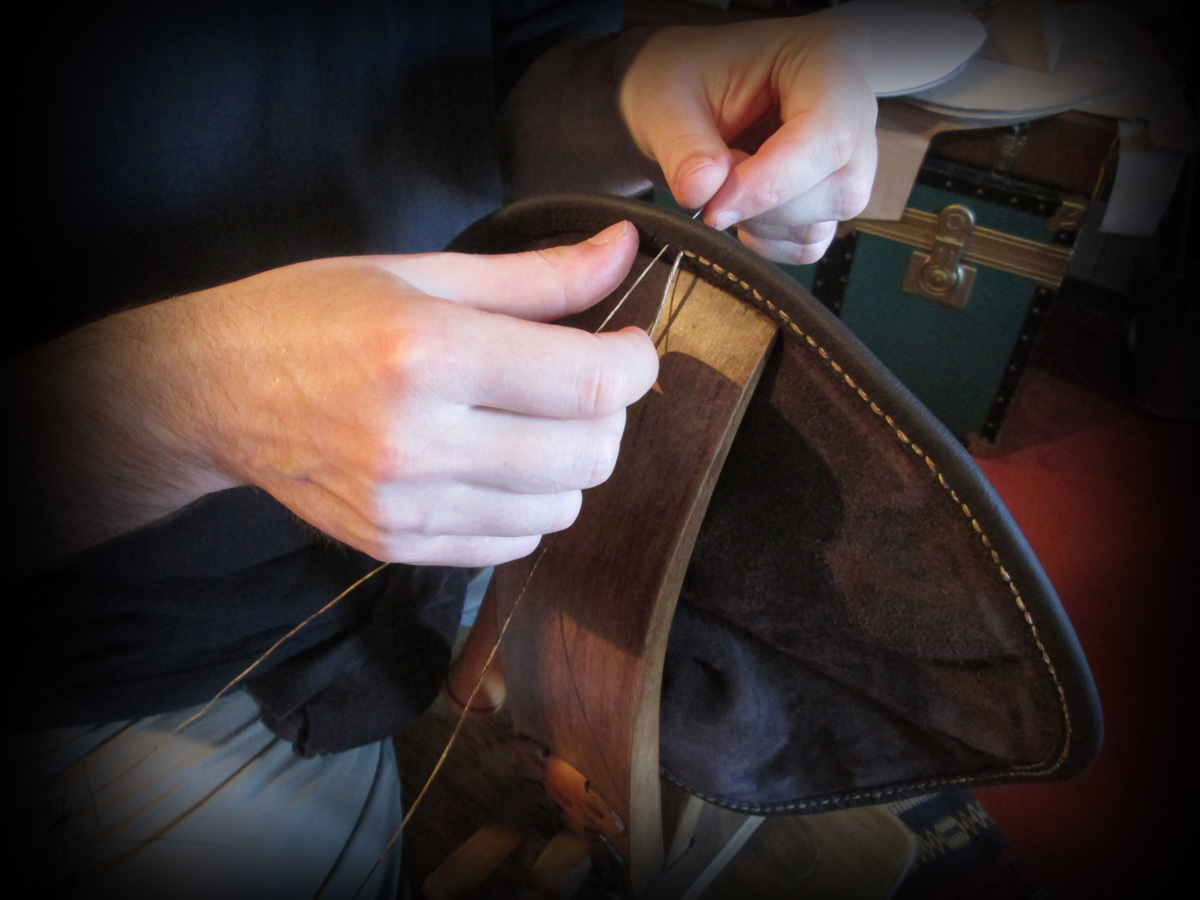 Hand stitching a leather bag