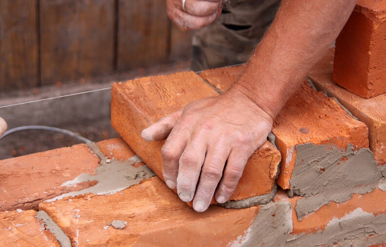 constructing-builders-mason-hands-building-brick-2919jpg